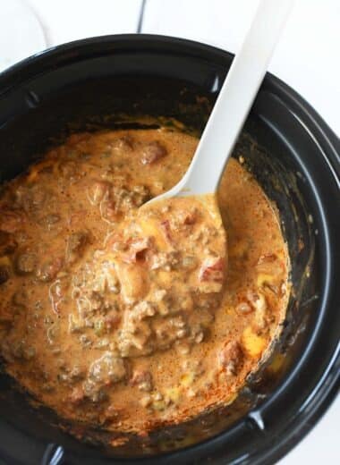Cheesy Slow Cooker Taco Dip with a grey spoon.