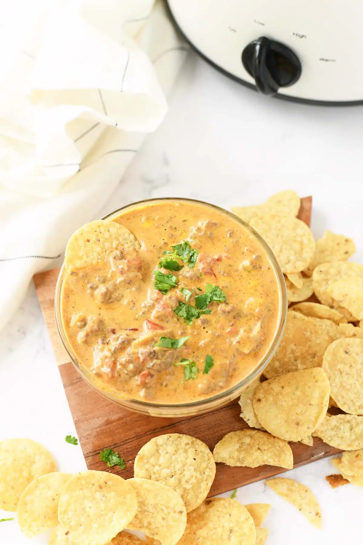 Cheesy Velveeta Taco Dip in a glass bowl with chips.