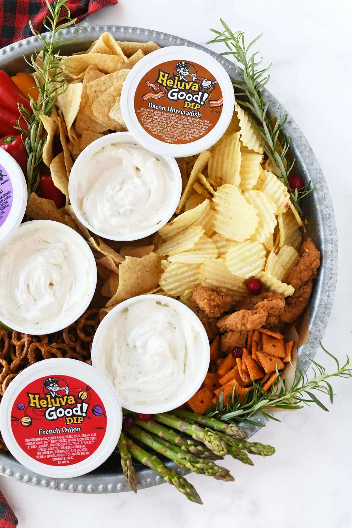 Heluva Good Dips on a holiday themed board with chips and chicken.