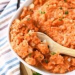 Mashed Turnips and Carrots on a wooden spoon.