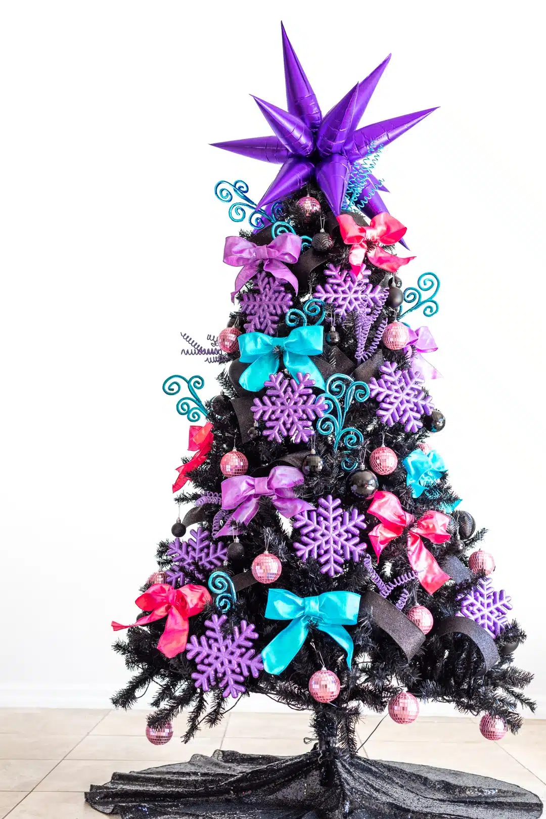 Black Christmas Tree with colorful ornaments.