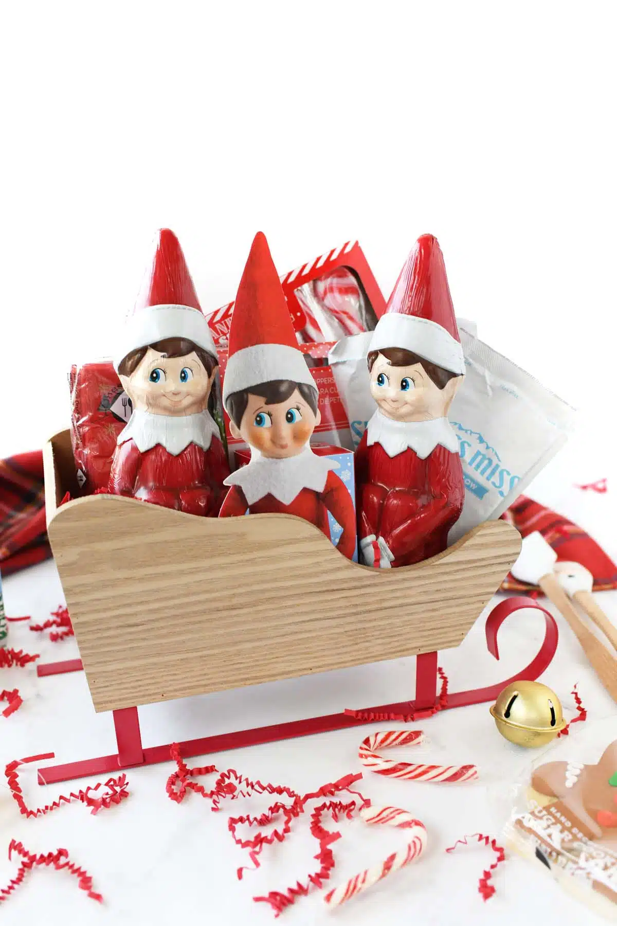Elf on the shelf candy in a red wooden sleigh gift idea.