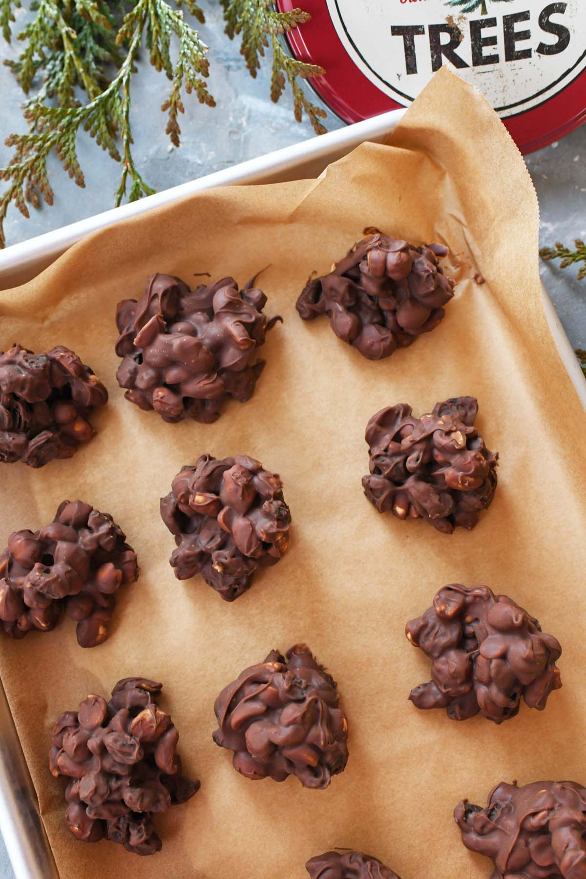 Raisin and peanut clusters on a parchment-lined baking sheet.