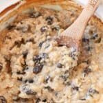 Creamy baked rice pudding in a spoon with raisins.
