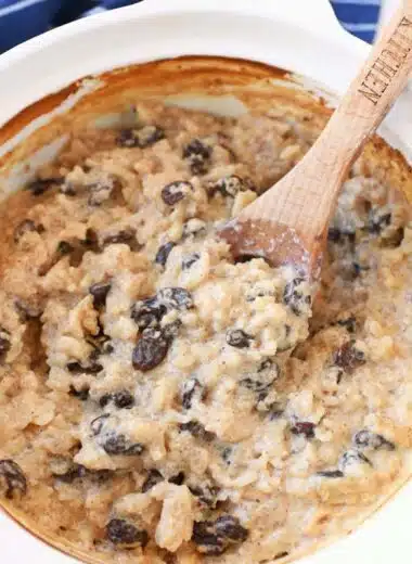 Creamy baked rice pudding in a spoon with raisins.