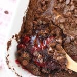 Chocolate Strawberry Dump Cake with a wooden spoon.