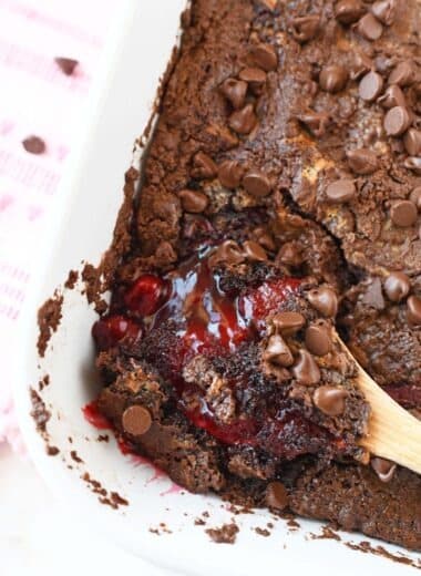 Chocolate Strawberry Dump Cake with a wooden spoon.