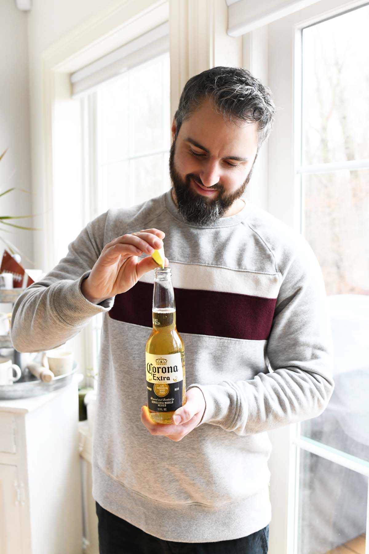 Man with Corona lime beer.