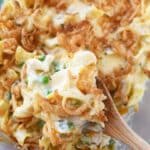 Tuna noodle casserole on a wooden spoon.