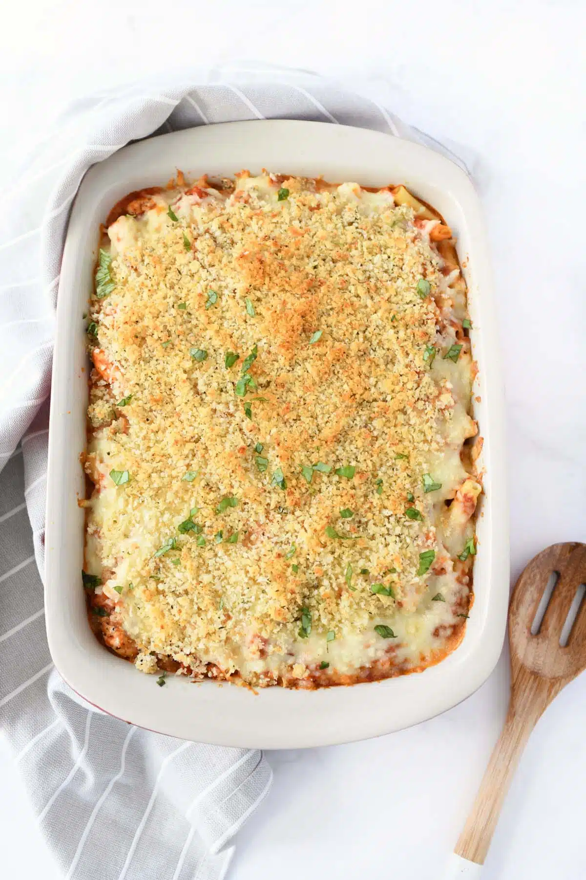 A golden-brown, baked chicken parmesan casserole with.