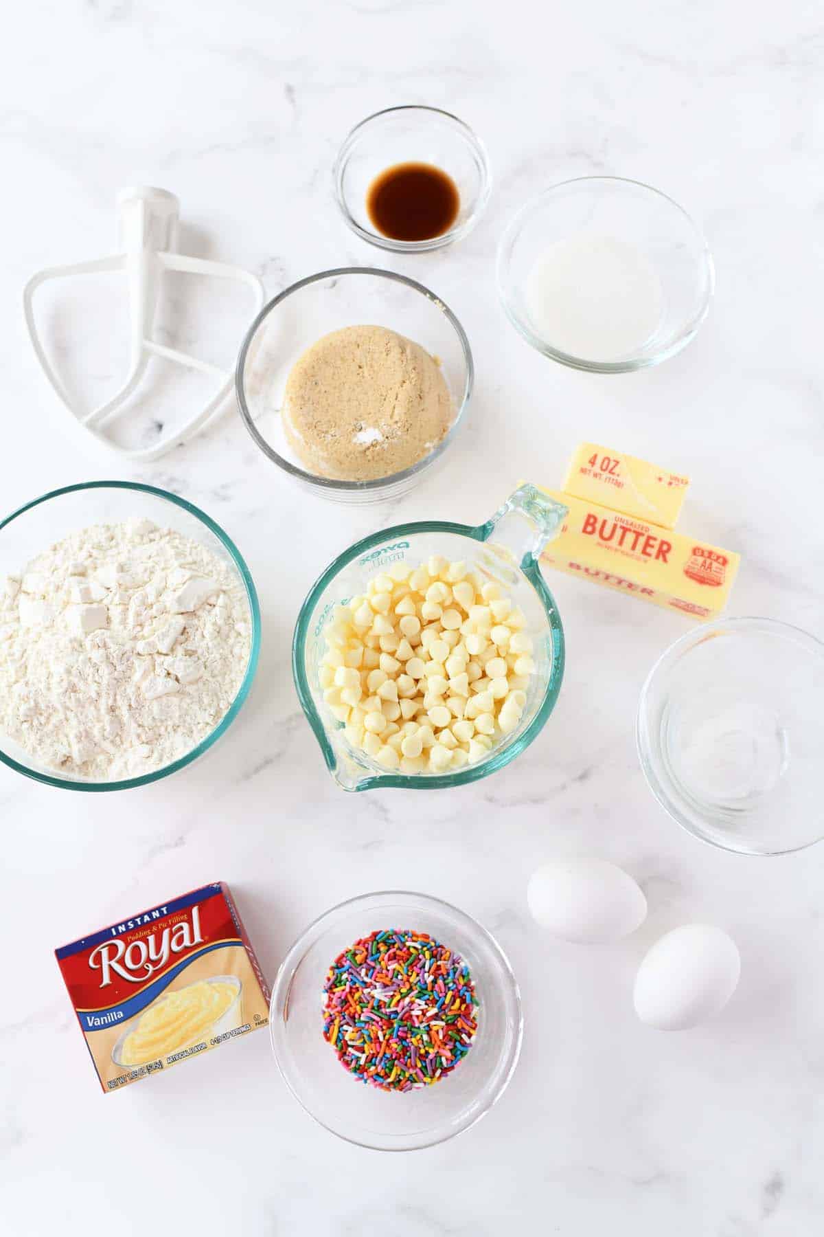 Vanilla pudding cookie recipe ingredients on a white table.