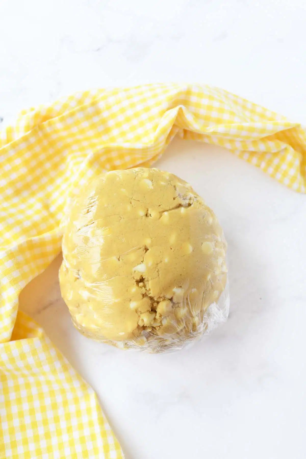 Lemon pudding dough in plastic wrap.