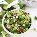 A white bowl loaded with colorful broccoli salad.