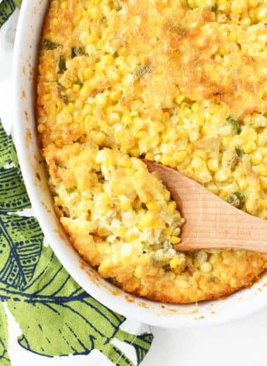 Golden-Brown Corn Pudding in a wooden spoon.