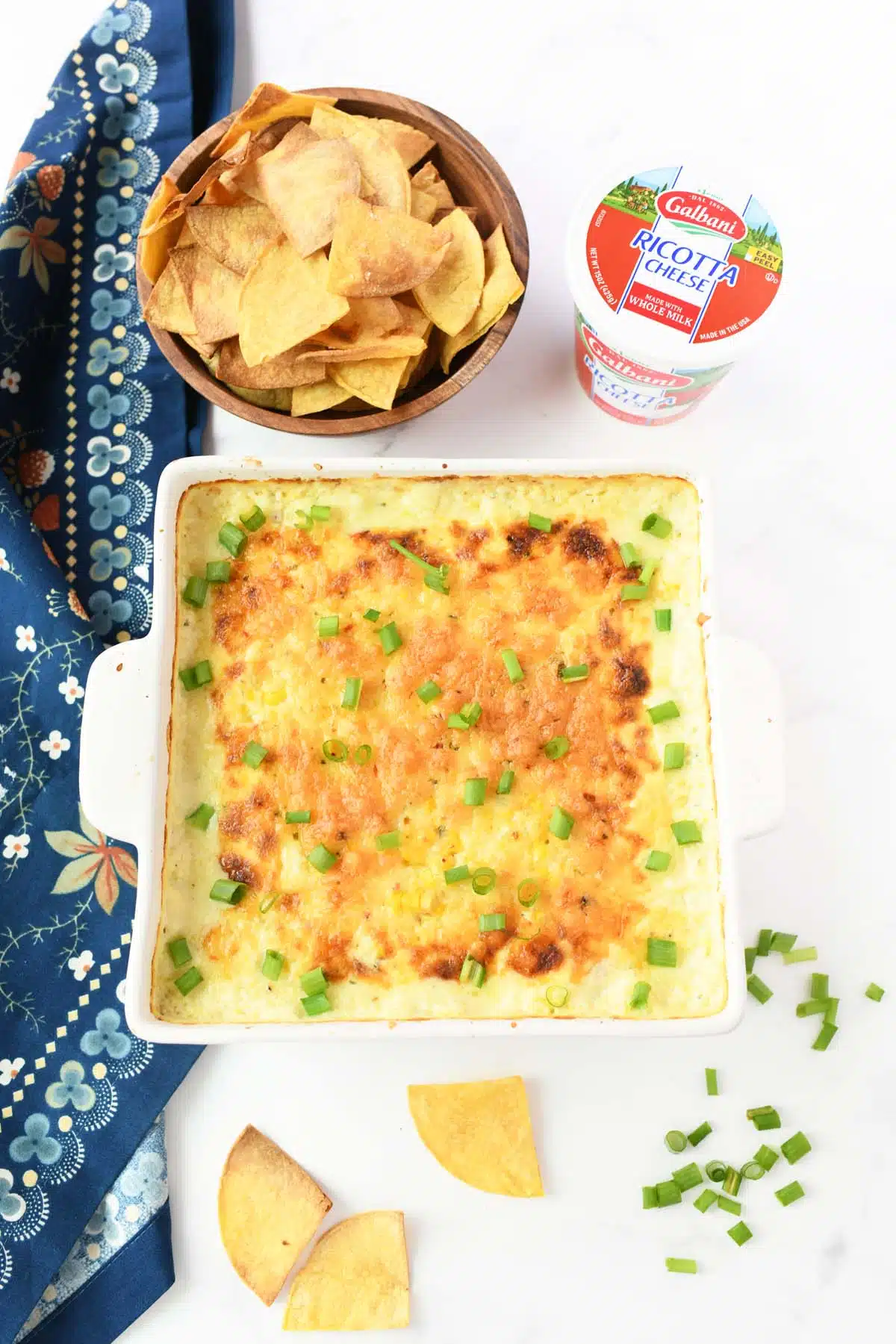 Golden-brown cheesy corn dip with chips and Galbani cheese.