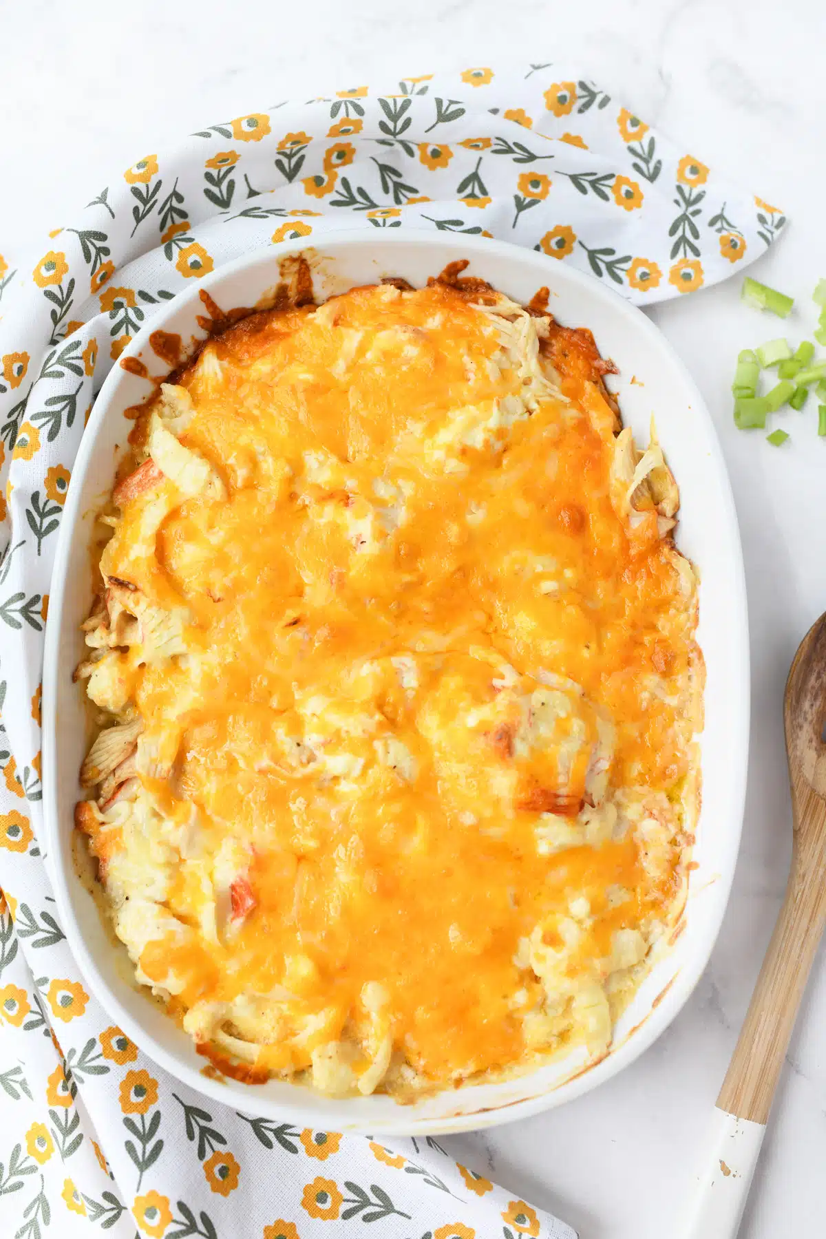 Cheesy crab casserole in a white oval baker.