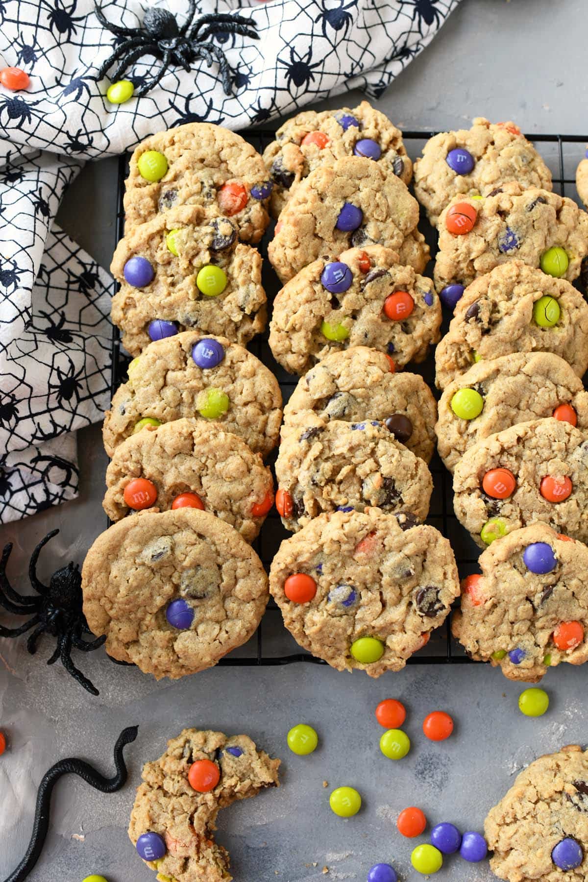 Colorful monster cookies on a cooling rack.