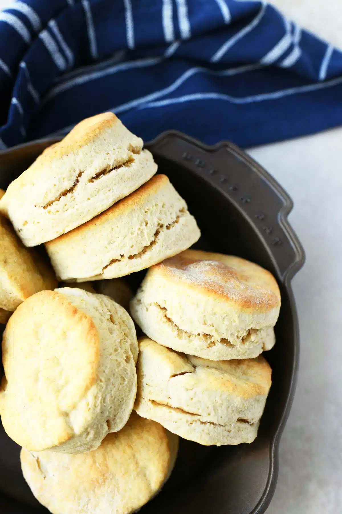 Heavy cream biscuits in a skillet with a blue napkin.