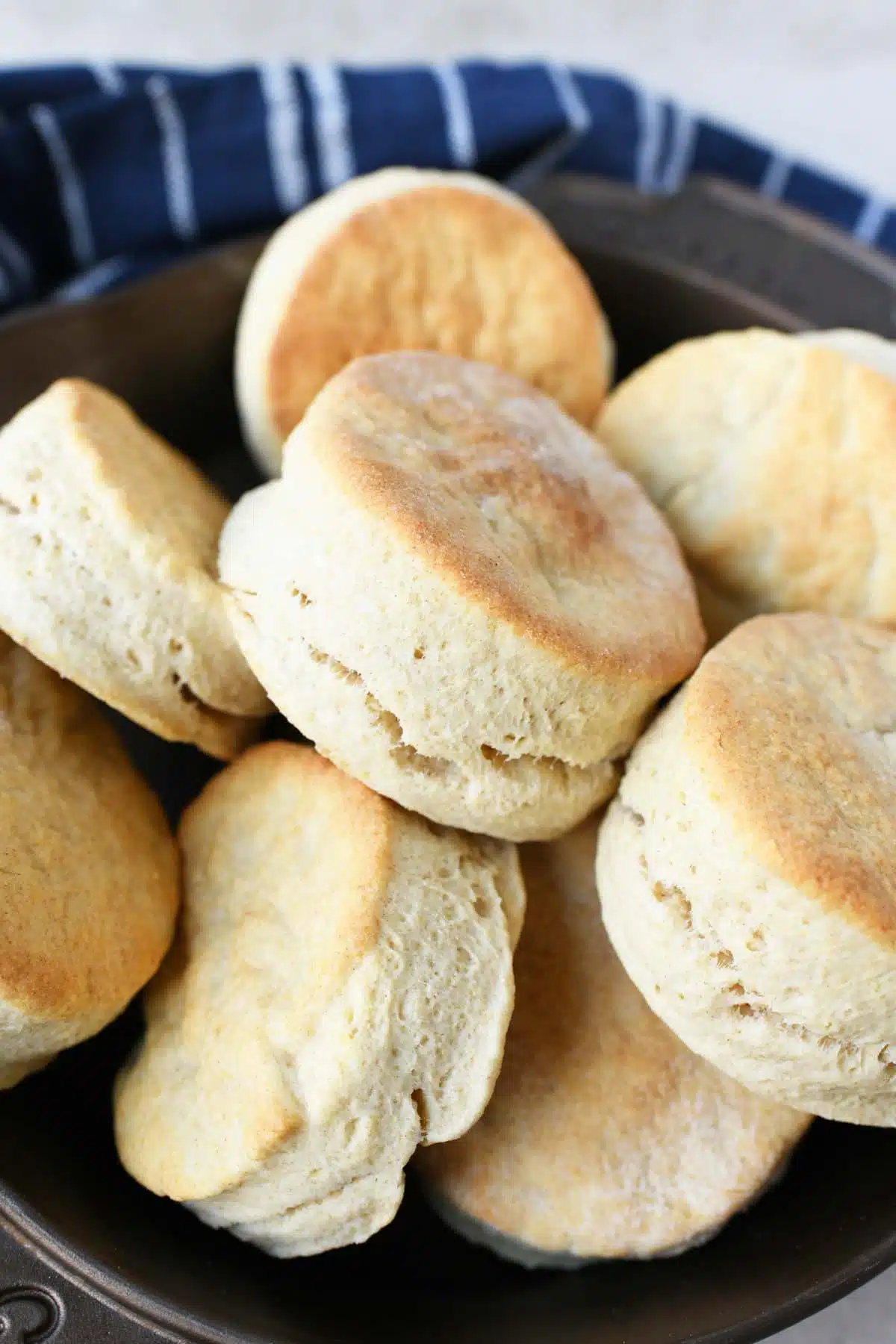 A cast iron skillet filled with fluffy 2-ingredient biscuits.