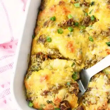 A silver spatula with sausage and crescent rolls.