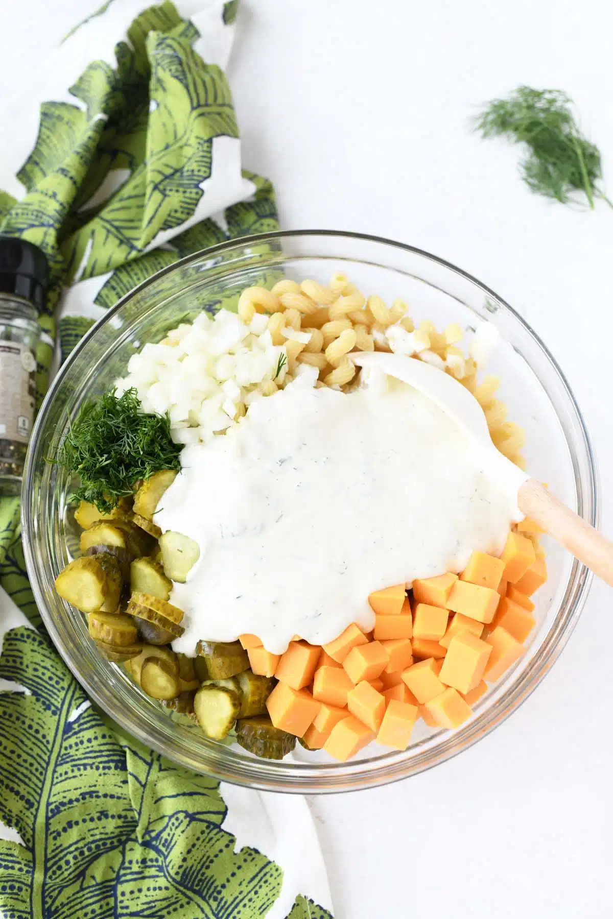 A glass dish with creamy pickle dressing.