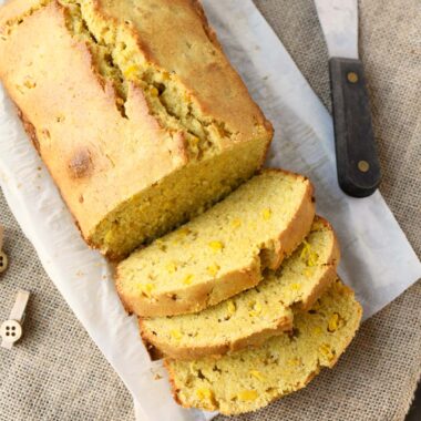 Sliced Sweet Cornbread loaf with real corn on burlap.