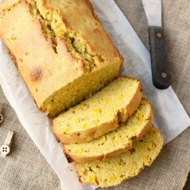 Sliced Sweet Cornbread loaf with real corn on burlap.