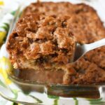 A slice of rhubarb cake on a silver spatula.
