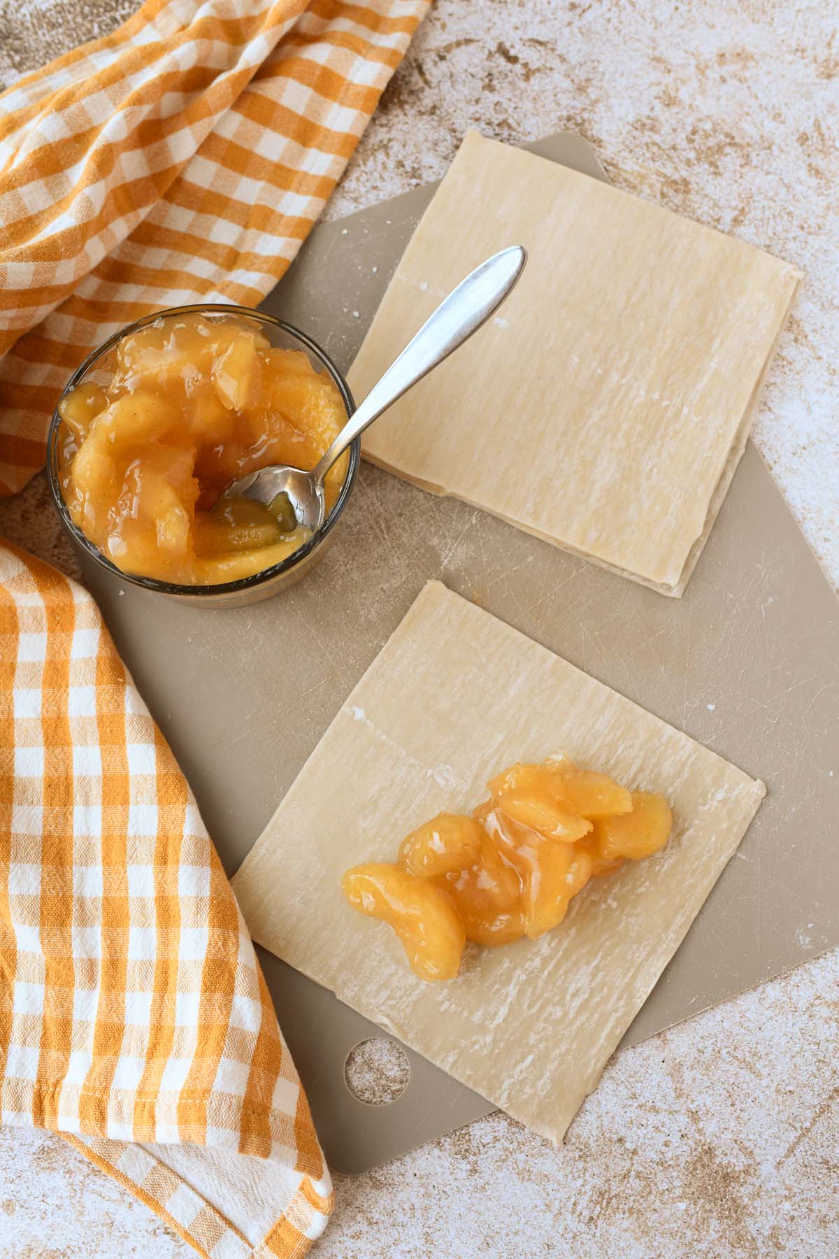 Apple pie filling inside a flat egg roll wrapper.