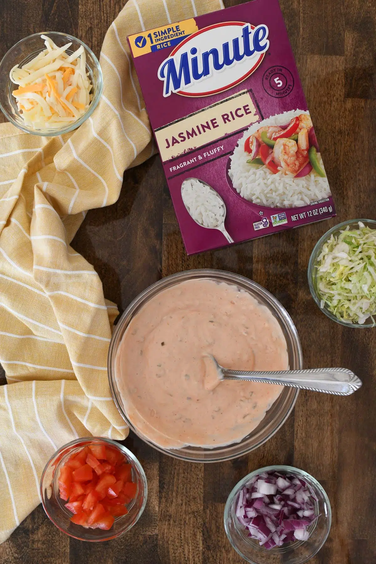 A bowl of homemade special sauce near ingredients like a box of purple Minute rice.