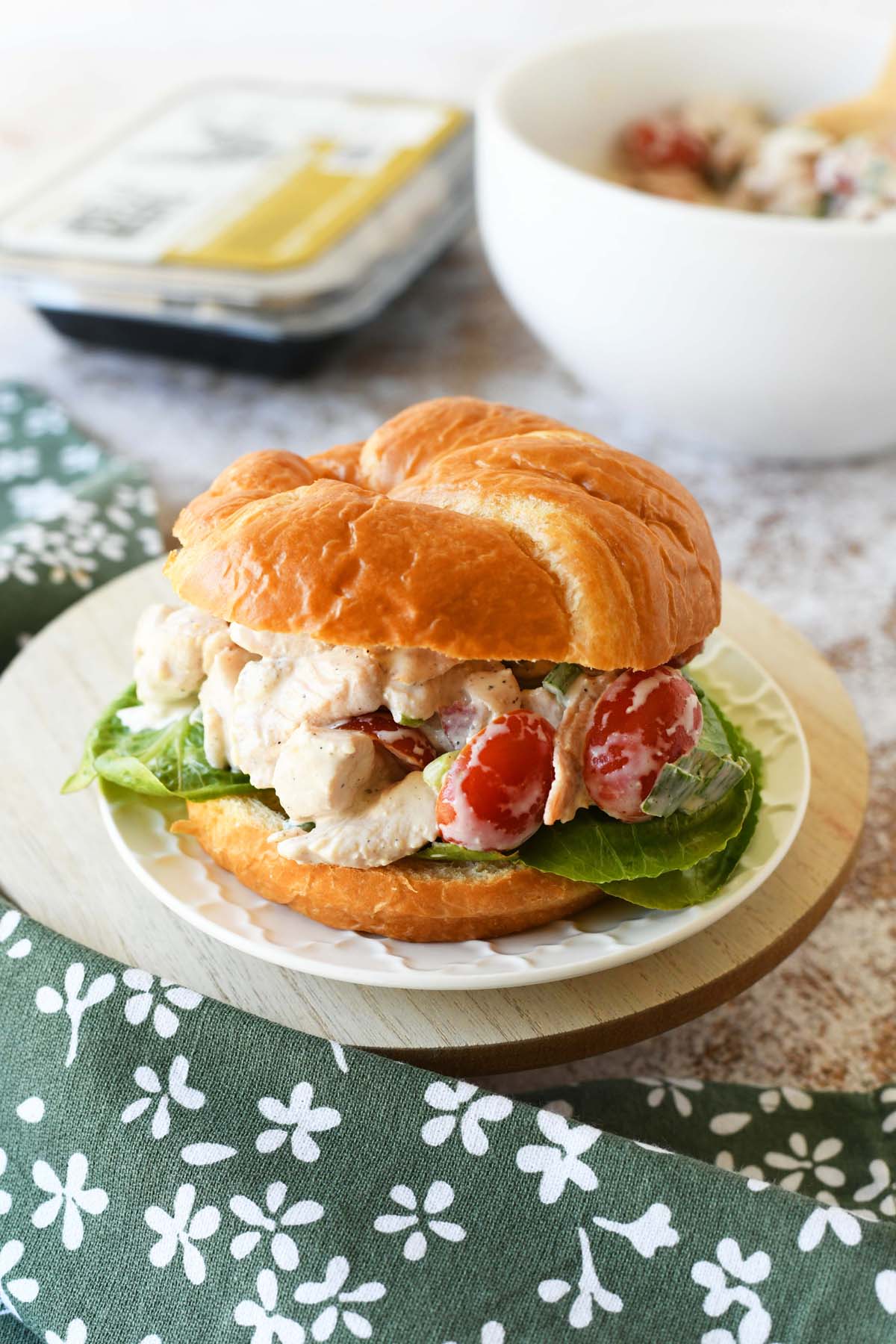 BLT chicken salad on a crossaint with a green napkin nearby.