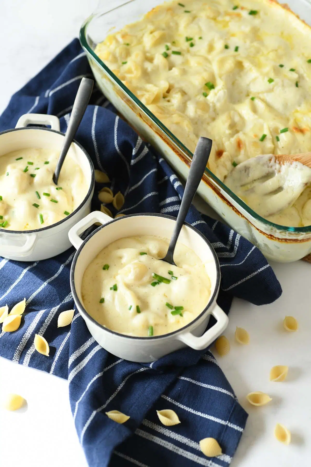 White Cheddar Baked Mac and Cheese in small white ramekins with blue striped napkins.