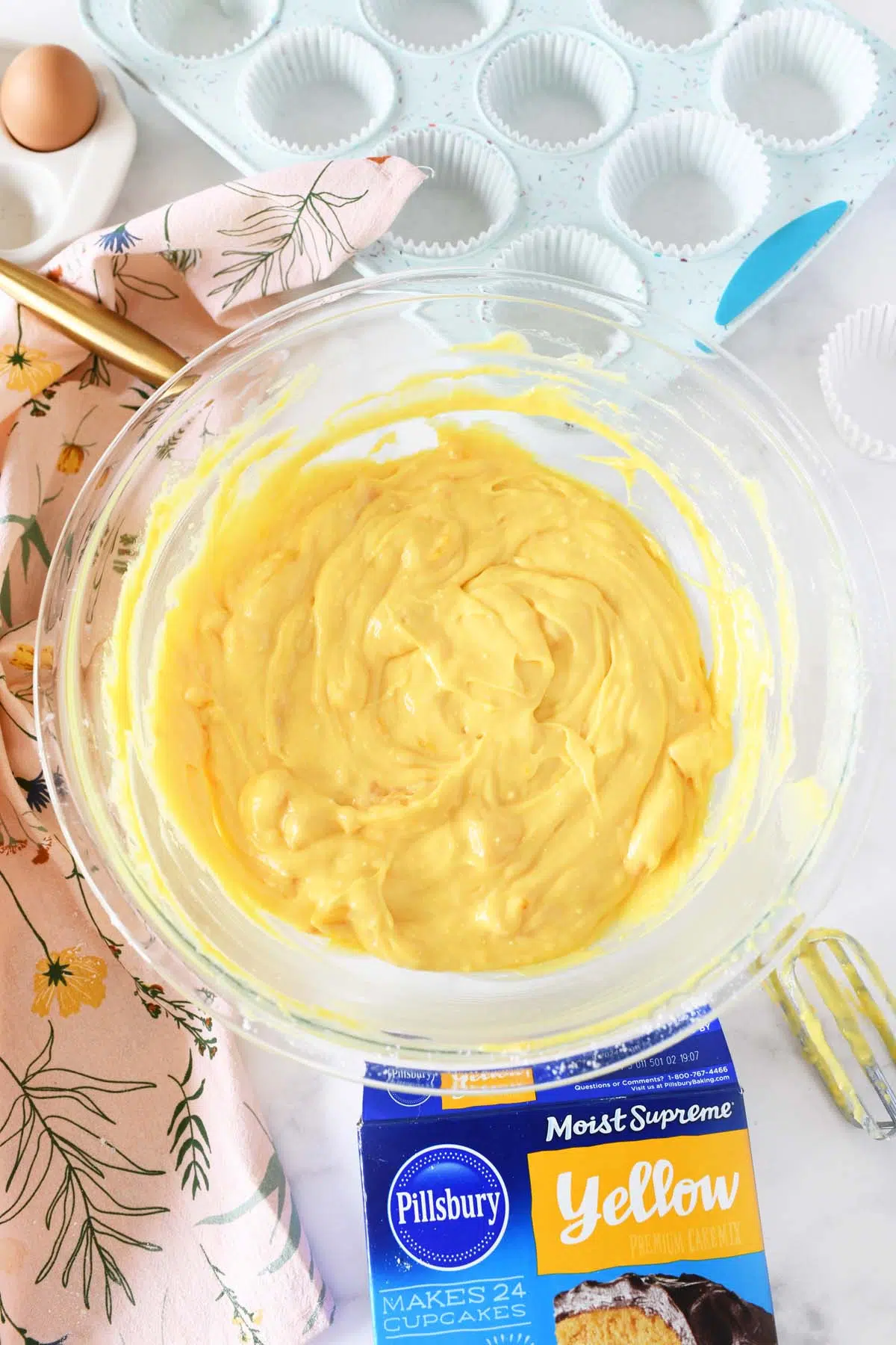 Fluffy yellow peach pie filling batter in a glass bowl.