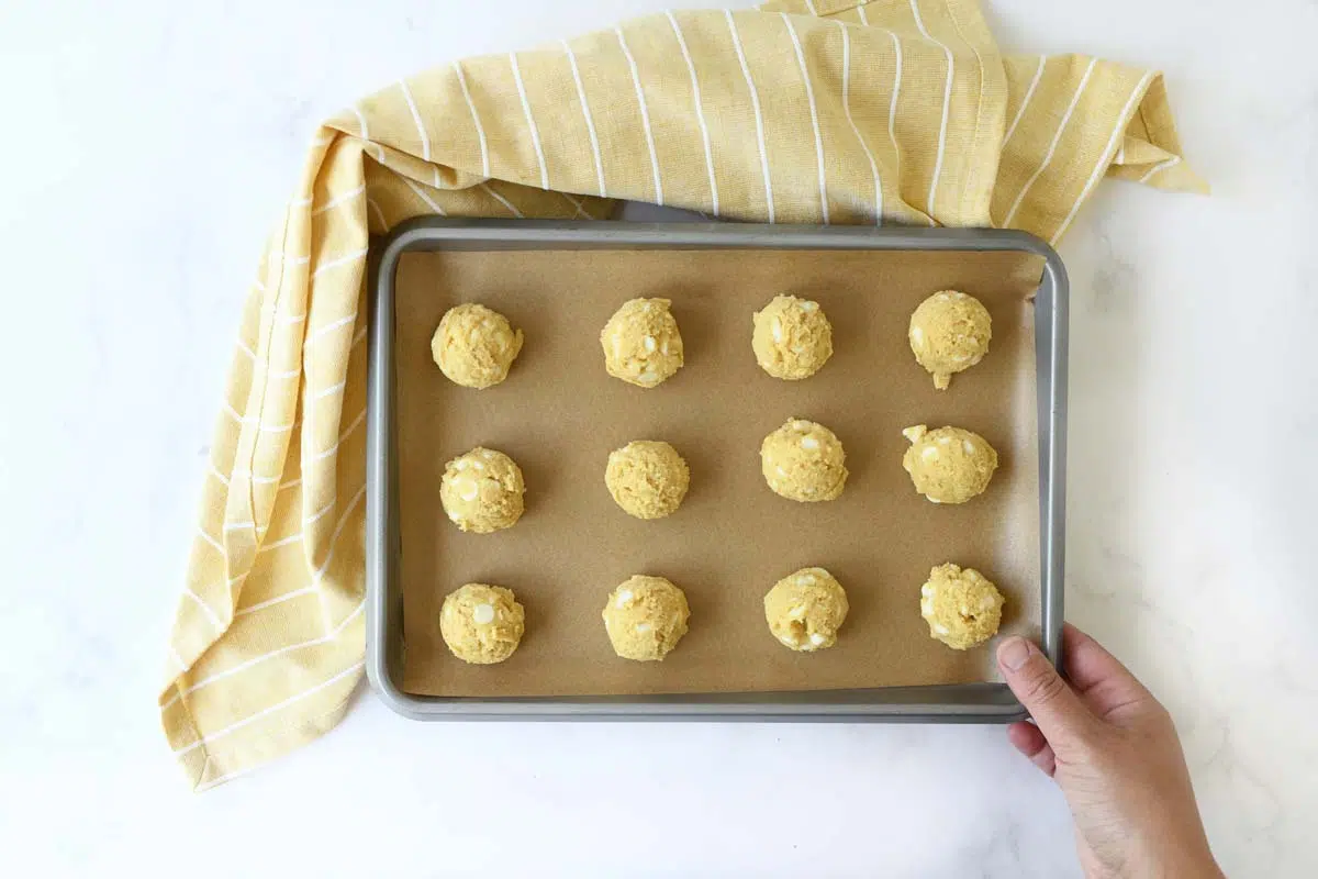 A baking sheet with banana pudding cookie scoops on it.
