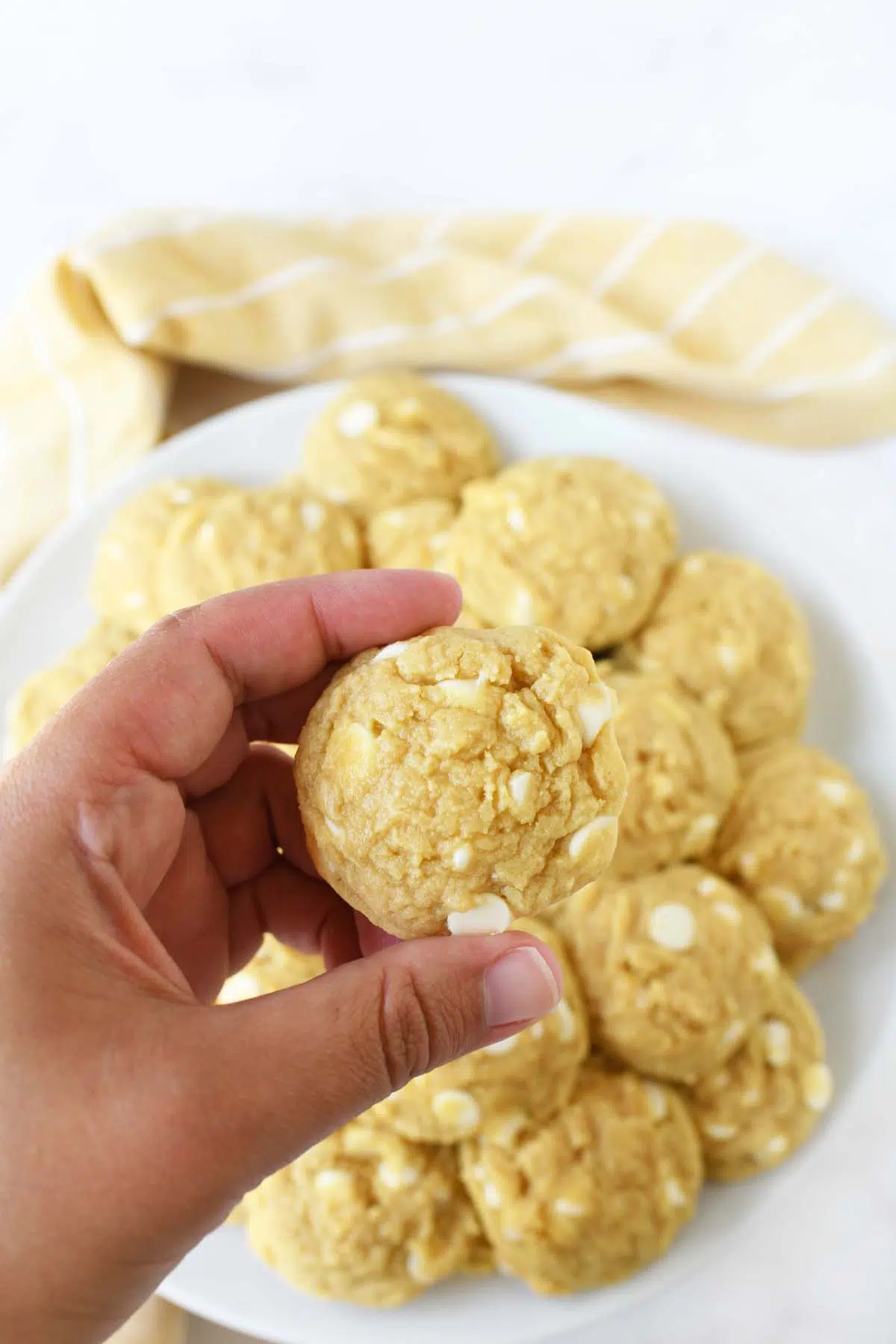 A banana pudding cookie in a white hand.