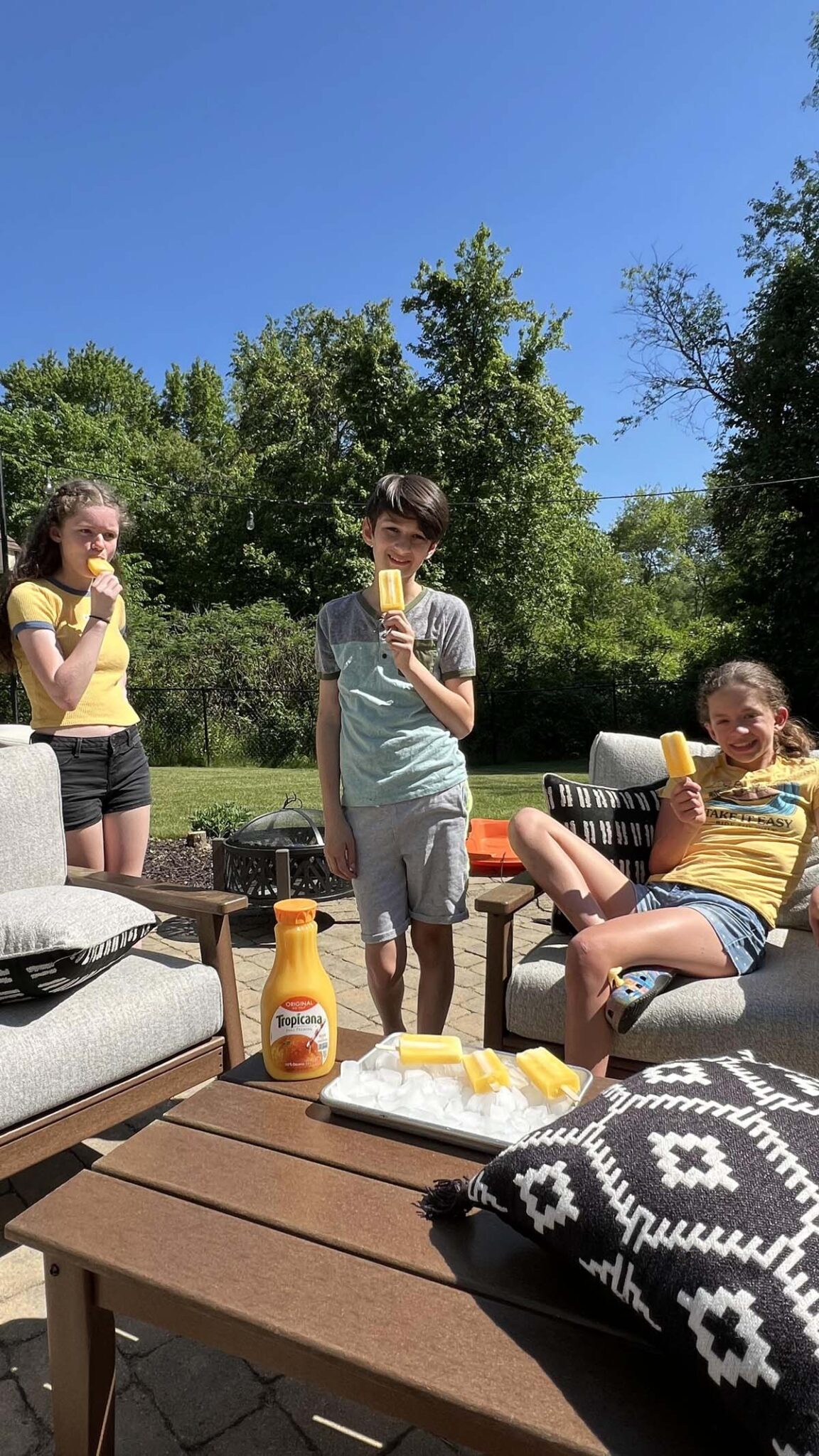 Kids outdoors enjoying ice pops.
