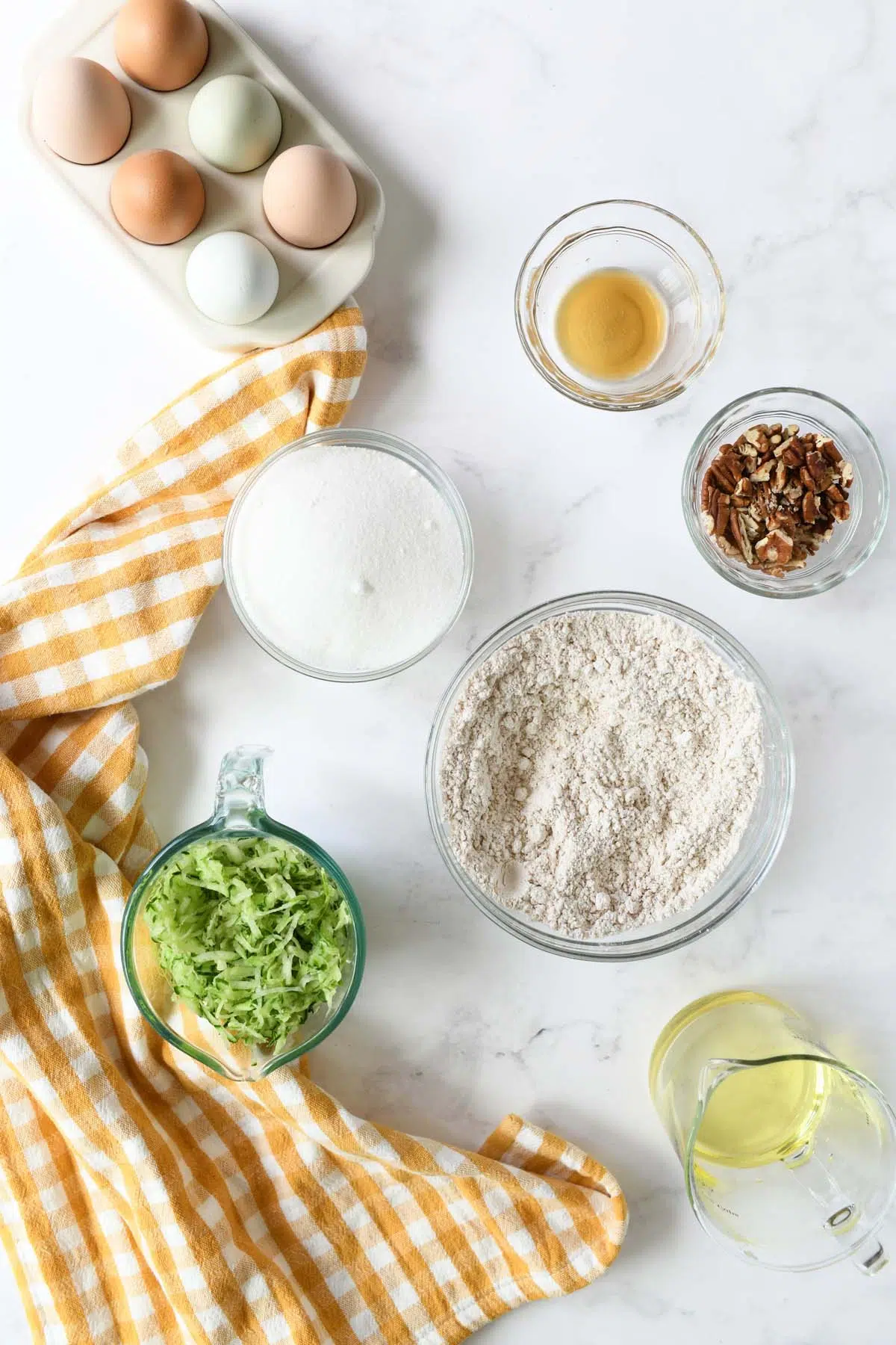 Cucumber bread ingredients on a white table.
