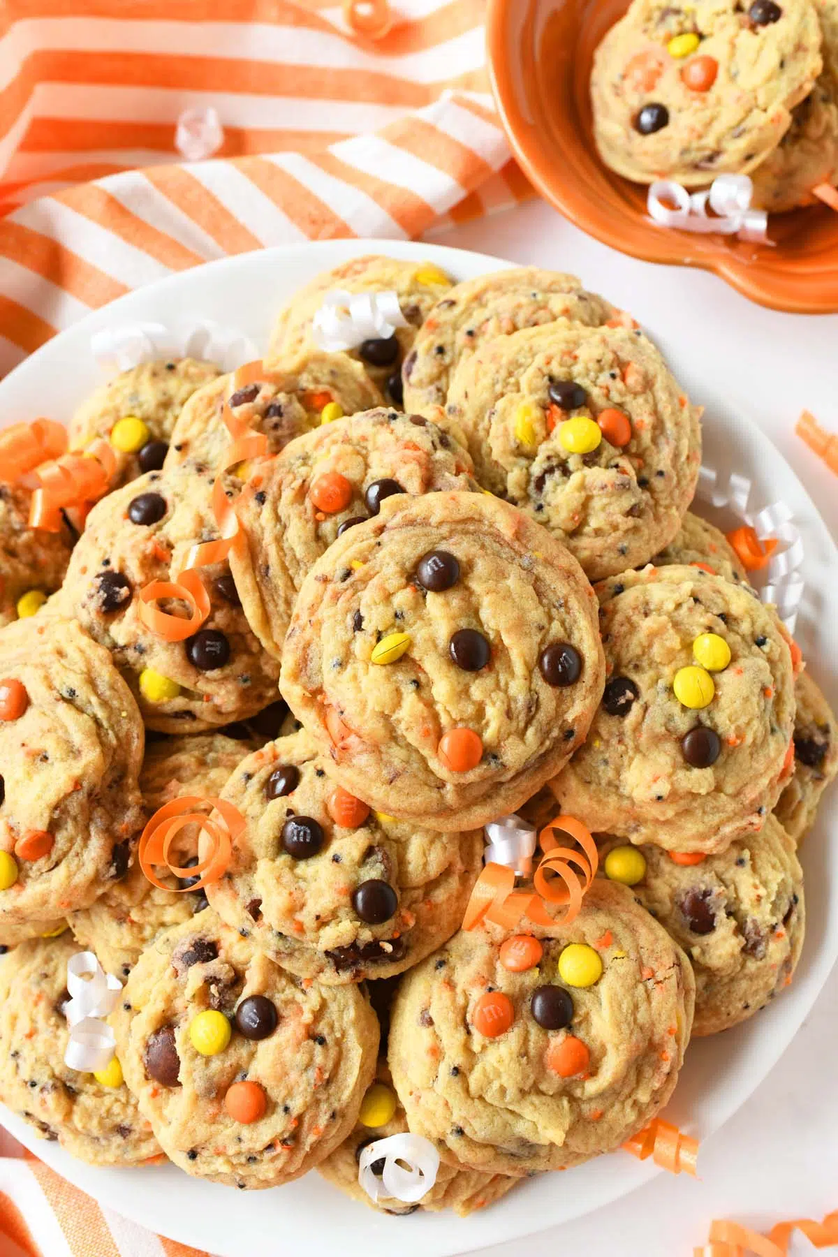 No spread candy cookies near an orange striped napkin.
