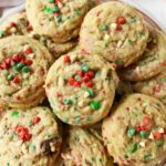 A plate of red, white, and green chocolate chip Christmas cookies.