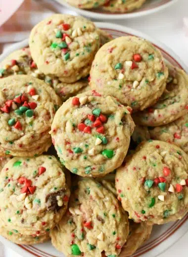 A plate of red, white, and green chocolate chip Christmas cookies.