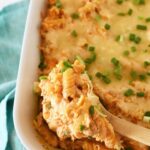 A wooden spoon with buffalo chicken pasta inside.
