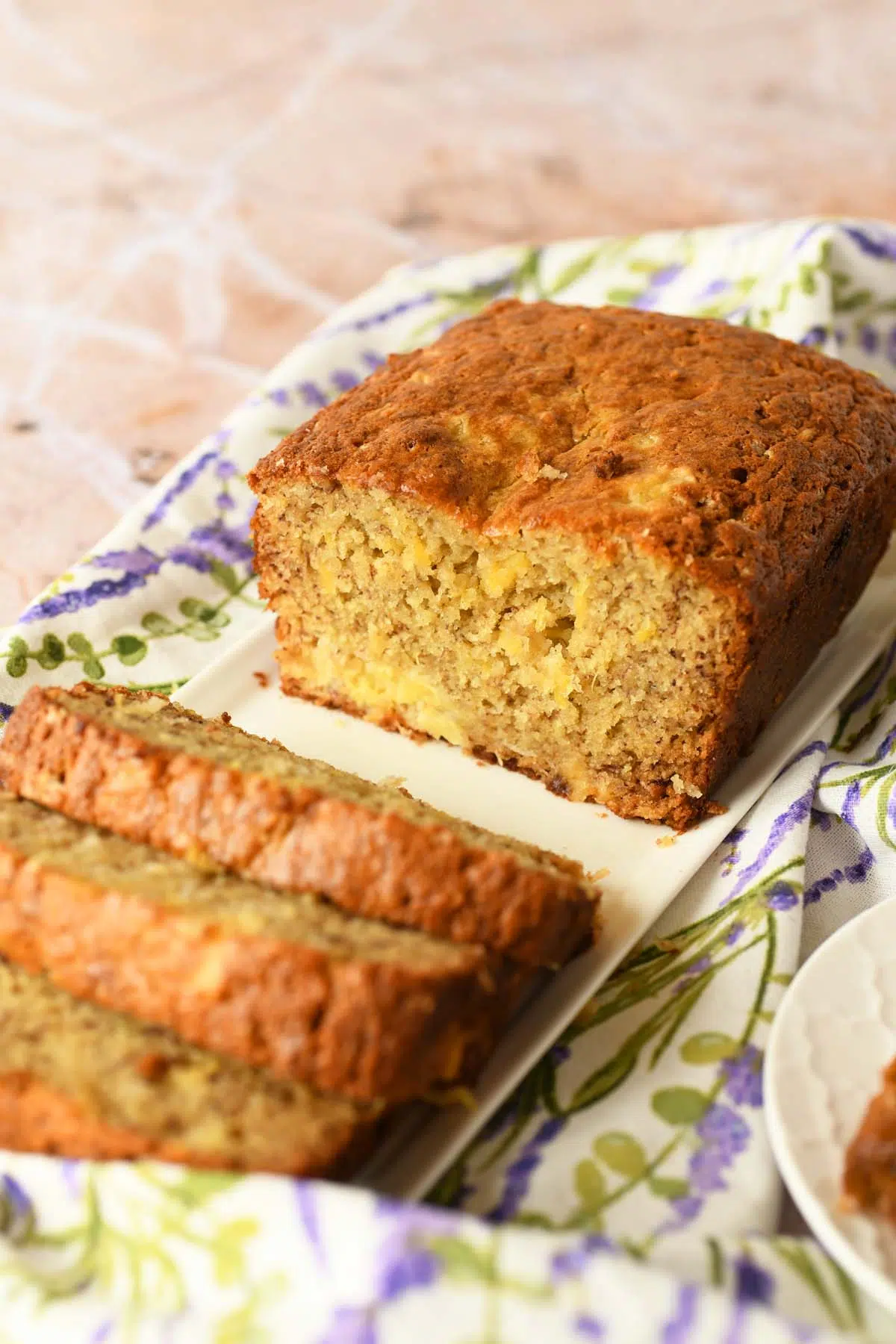 Sliced Pineapple Banana Bread on a white plate.