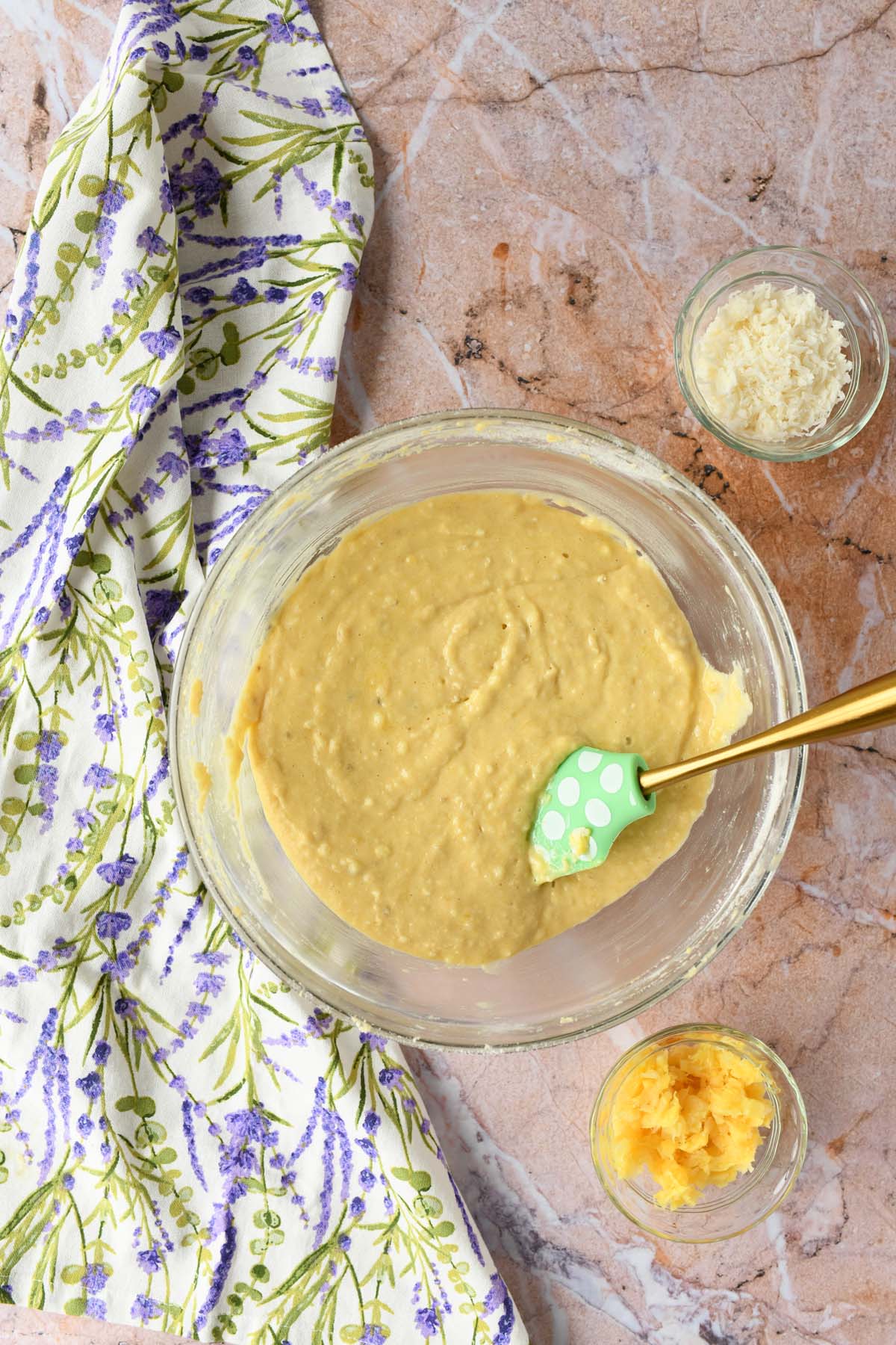 Yellow banana batter in a glass bowl.