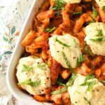 Up close shot of ricotta dollops on baked ziti.