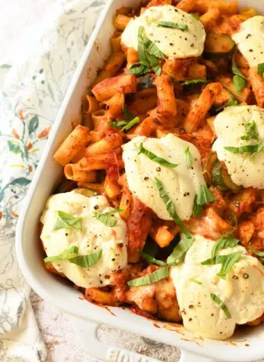 Up close shot of ricotta dollops on baked ziti.