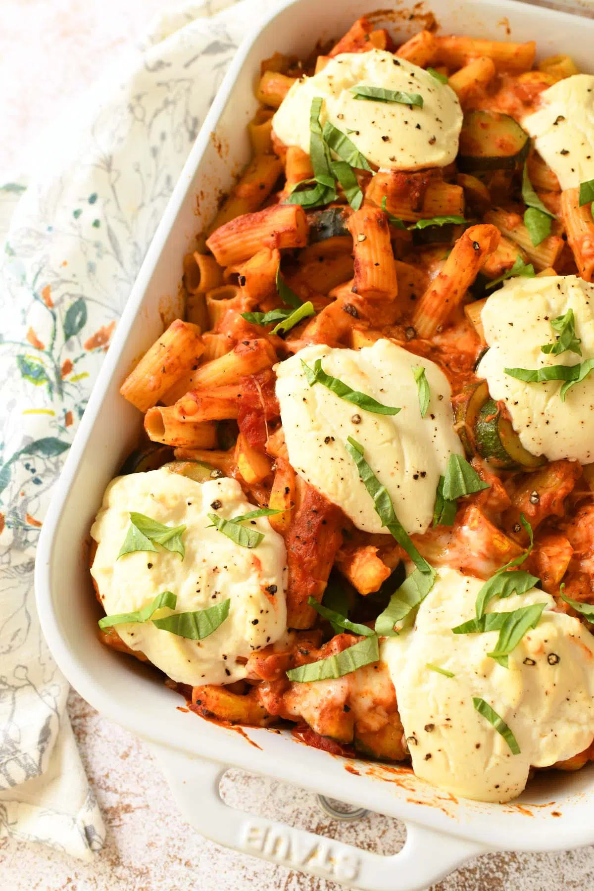 Up close shot of ricotta dollops on baked ziti.