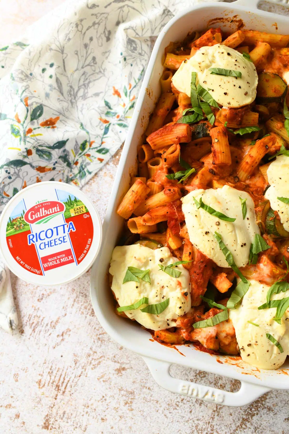 Baked ziti near ricotta cheese.