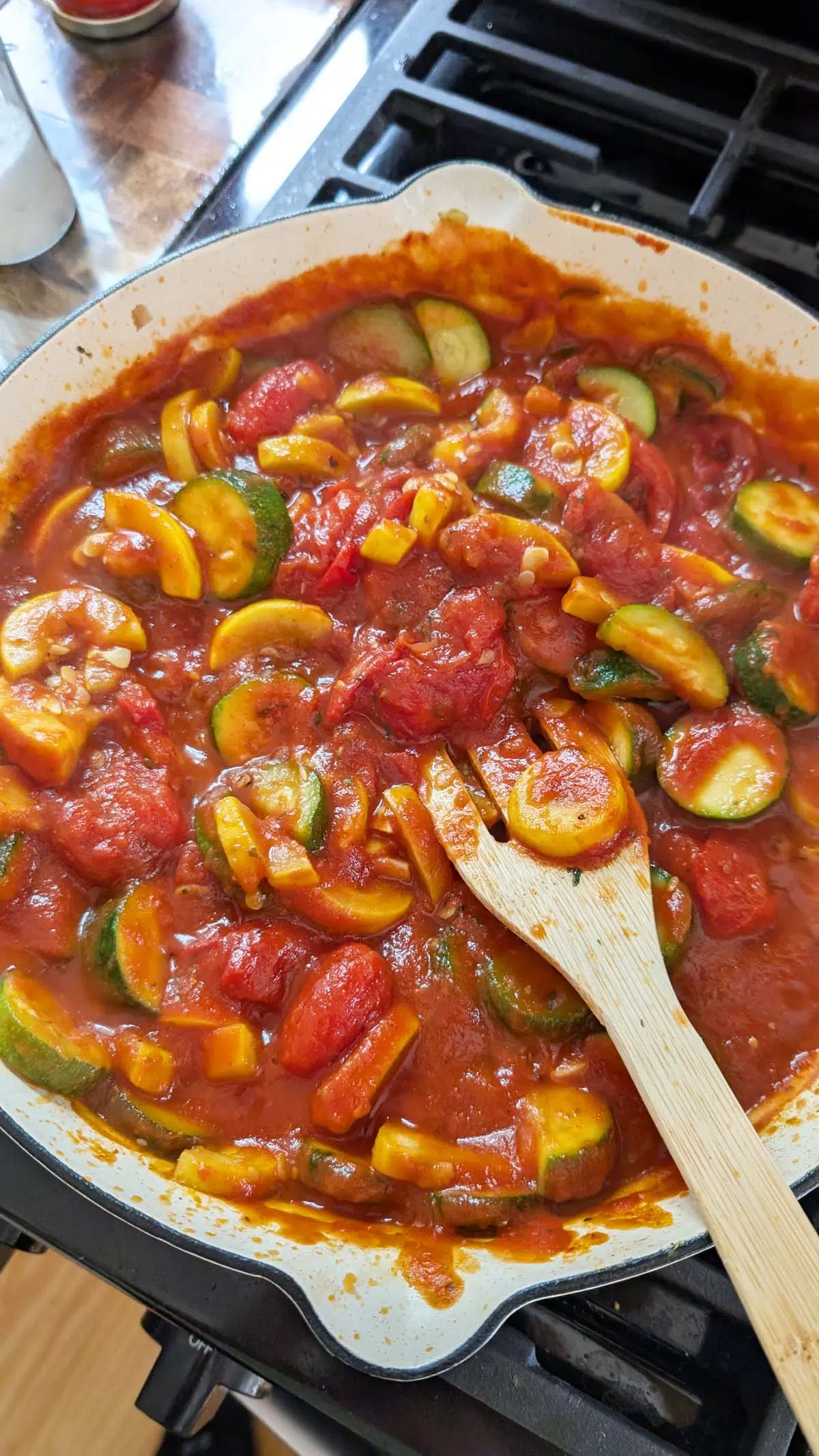 sauteed summer squash in a white skillet.