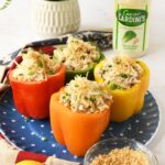 Rainbow stufed peppers with chicken salad on a blue, star plate.