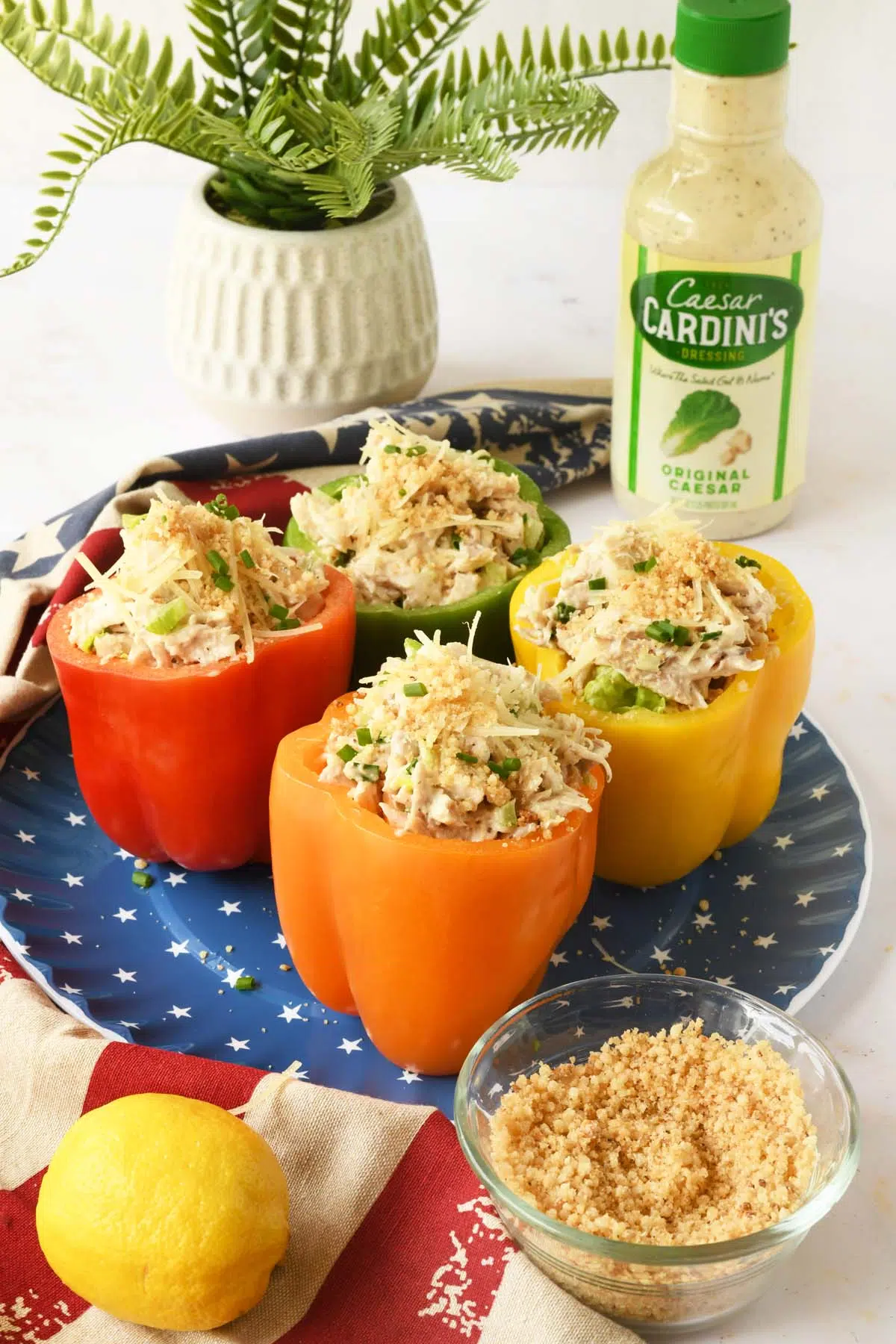 Rainbow stufed peppers with chicken salad on a blue, star plate.